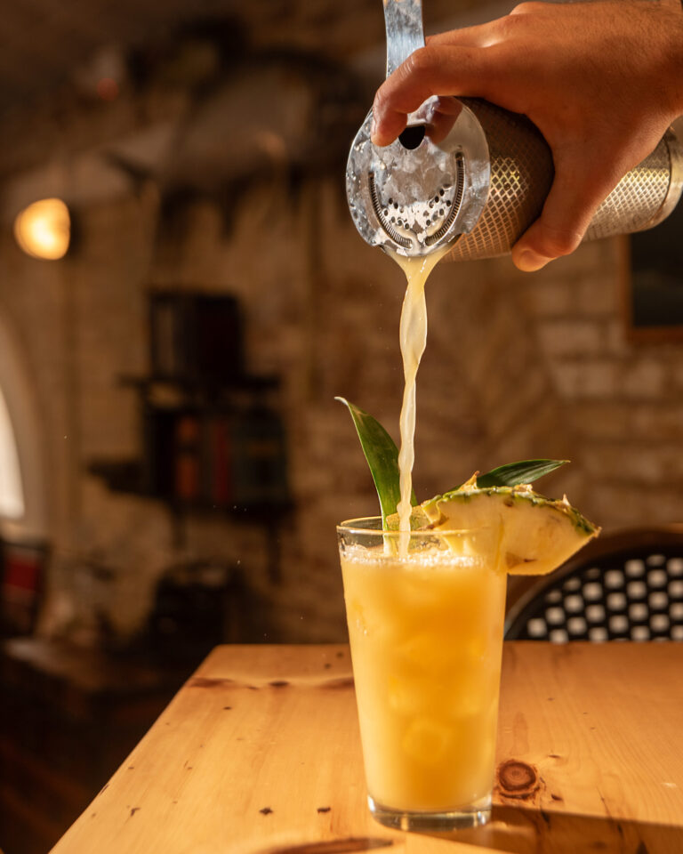 making a painkiller cocktail at bar 1